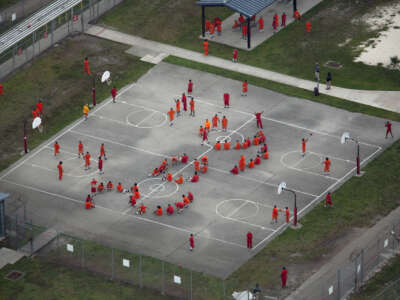 In an aerial view from a helicopter, imprisoned immigrants are seen spelling out "SOS" with their bodies at Krome Detention Center run by United States Immigration and Customs Enforcement in Miami, Florida, on July 4, 2025.