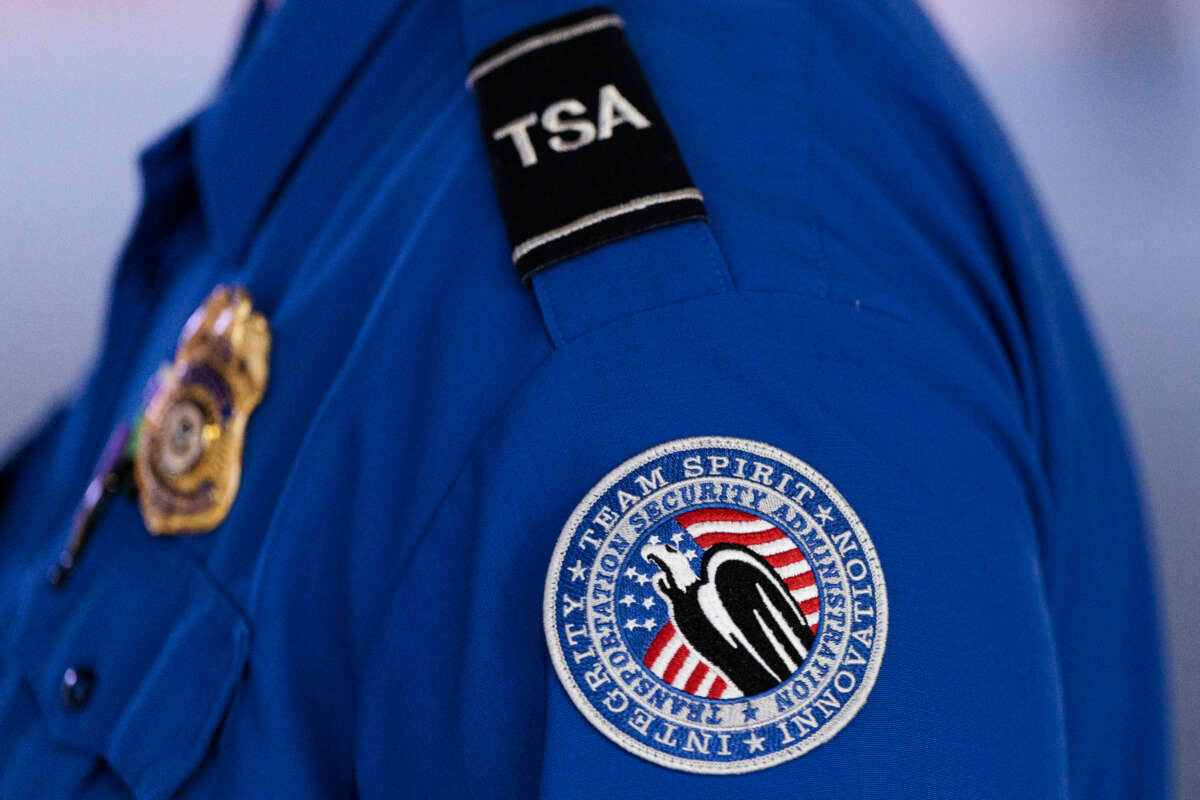 A detailed view of a Transportation Security Administration (TSA) patch on an employee's shirt at Orlando International Airport (MCO) on November 9, 2025, in Orlando, Florida.