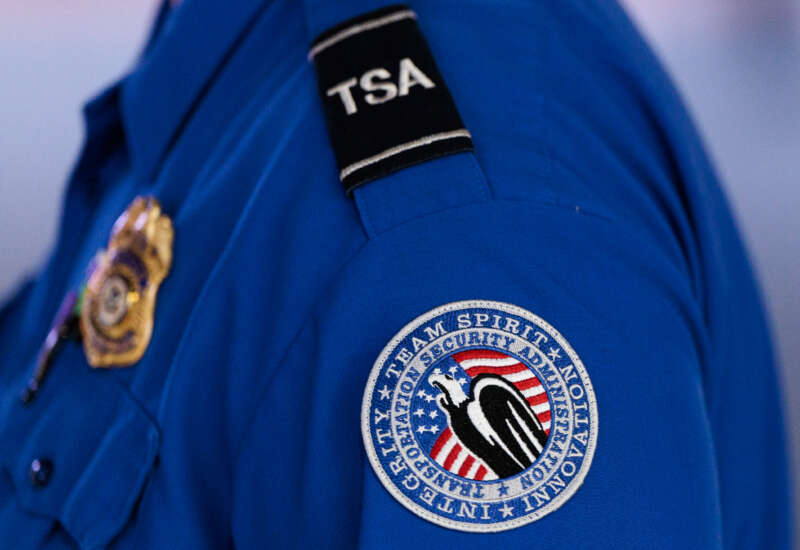 A detailed view of a Transportation Security Administration (TSA) patch on an employee's shirt at Orlando International Airport (MCO) on November 9, 2025, in Orlando, Florida.