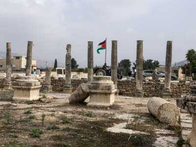 A man drives his tractor past ruins at the archaeological site of Sebastia, west of the occupied West Bank city of Nablus, on November 30, 2025.