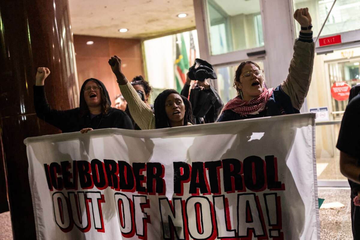 People protest against ICE and Border Patrol outside of City Hall in New Orleans, Louisiana, on December 1, 2025.