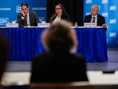 Members of the CDC Advisory Committee on Immunization Practices (ACIP) are seen as a presenter from Vaccines for Children (VfC) speaks during an ACIP meeting at CDC Headquarters on December 4, 2025, in Atlanta, Georgia.