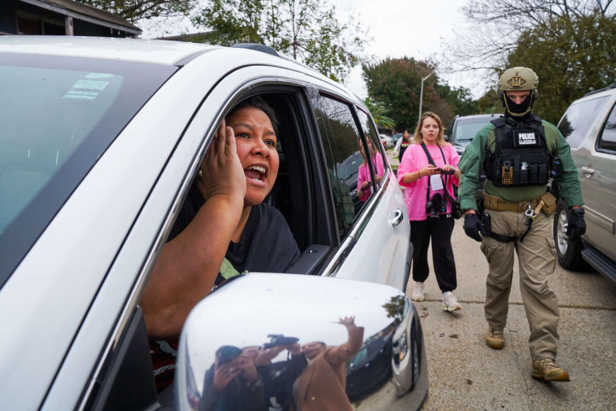 A woman yells at U.S. Border Patrol agents while they conduct an immigration enforcement operation in a neighborhood on December 5, 2025, in New Orleans, Louisiana.