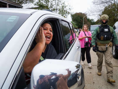 A woman yells at U.S. Border Patrol agents while they conduct an immigration enforcement operation in a neighborhood on December 5, 2025, in New Orleans, Louisiana.
