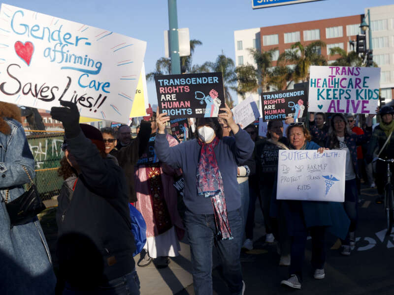 Members of Rainbow Families Action march from Bay Street in Emeryville, California, on December 8, 2025 to the Sutter corporate offices on Powell Street to protest the end of gender-affirming care to patients under age 19.