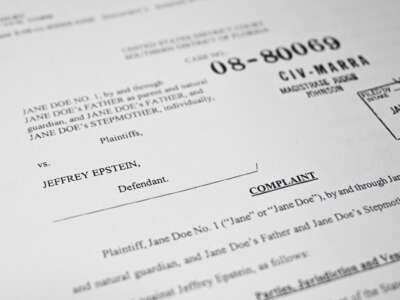 This photo illustration taken in Washington, D.C., on December 19, 2025, shows a court document after the US Justice Department began releasing the long-awaited records from the investigation into the politically explosive case of convicted sex offender Jeffrey Epstein.