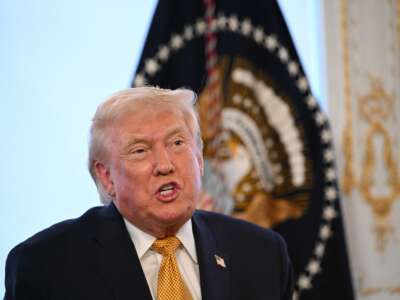 U.S. President Donald Trump participates in calls to U.S. service members, on Christmas Eve, from the Mar-a-Lago club in Palm Beach, Florida, December 24, 2025.