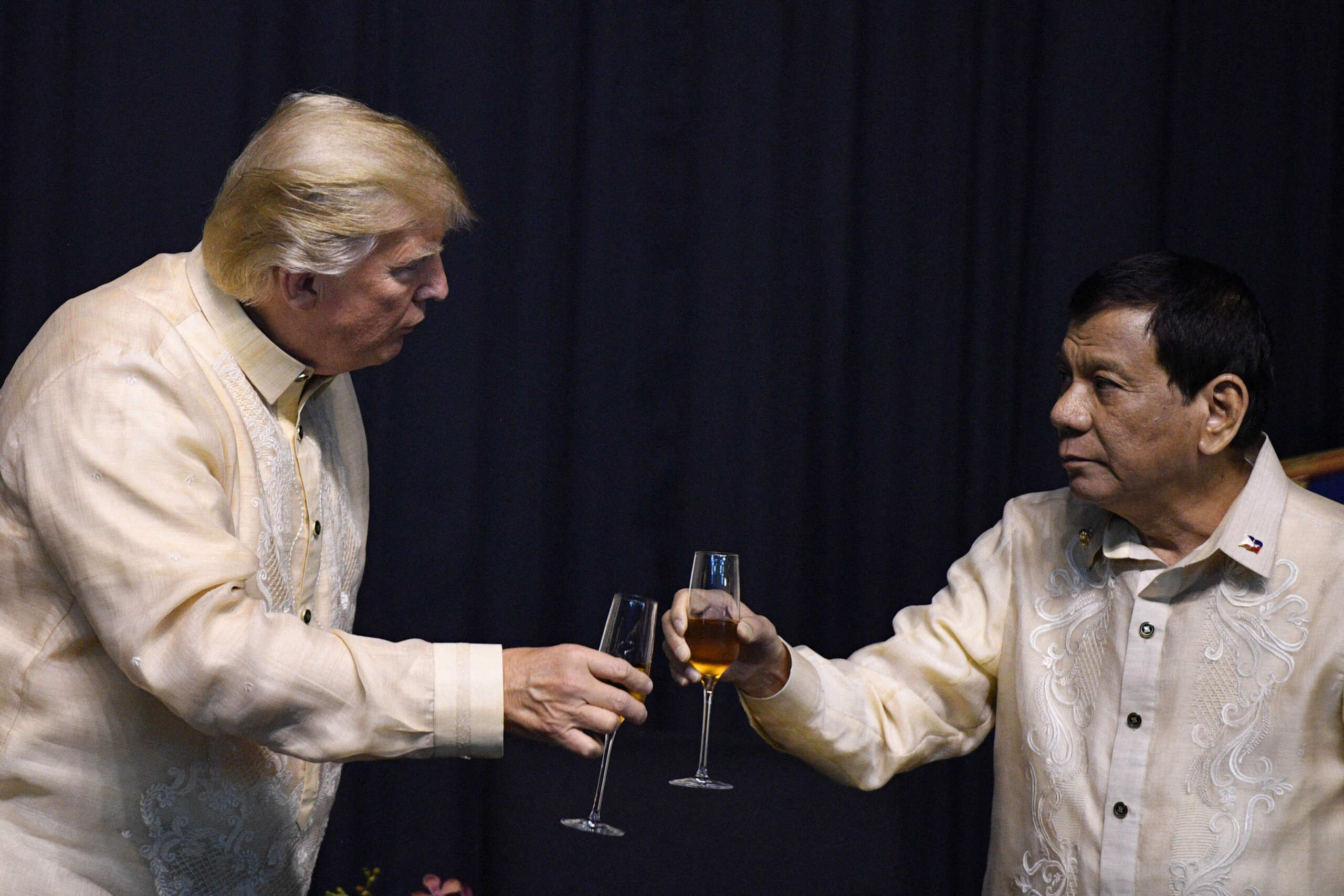 Then-Philippine President Rodrigo Duterte toasts U.S. President Donald Trump during a special gala celebration dinner for the Association of Southeast Asian Nations in Manila on November 12, 2017.