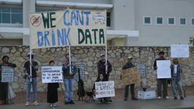 Protesters outside the Doña Ana County Government Center in Las Cruces, New Mexico, before a Doña Ana County Board of County Commissioners vote on Project Jupiter on September 19, 2025.