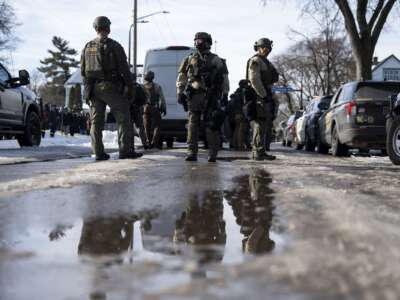 Hennepin County Sheriff's officers look on as members of law enforcement hold a perimeter around the scene of a shooting by an ICE agent during federal law enforcement operations on January 7, 2026 in Minneapolis, Minnesota.