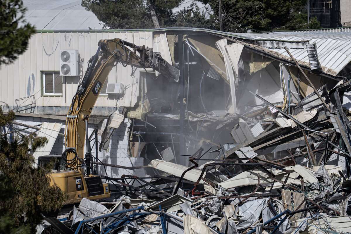 Heavy machinery pulling down a structure inside the UNRWA compound as the Israel Land Authority begins demolishing an UNRWA complex on January 20, 2026 in Jerusalem.