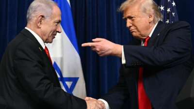 U.S. President Donald Trump and Israeli Prime Minister Benjamin Netanyahu shake hands as they arrive to speak to journalists during a joint press conference at Trump’s Mar-a-Lago residence in Palm Beach, Florida, on December 29, 2025.