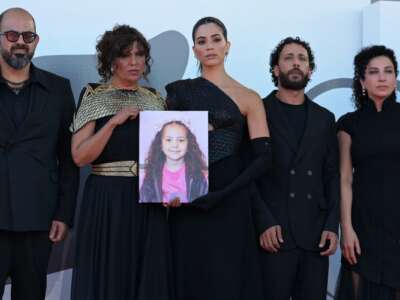 From left: actor Amer Hlehel, Tunisian director Kaouther Ben Hania, actress Saja Kilani, actor Motaz Malhees, actress Clara Khoury pose with a portrait of late Palestinian girl Hind Rajab, during the red carpet for the movie "The Voice of Hind Rajab" presented in competition at the 82nd International Venice Film Festival on September 3, 2025.