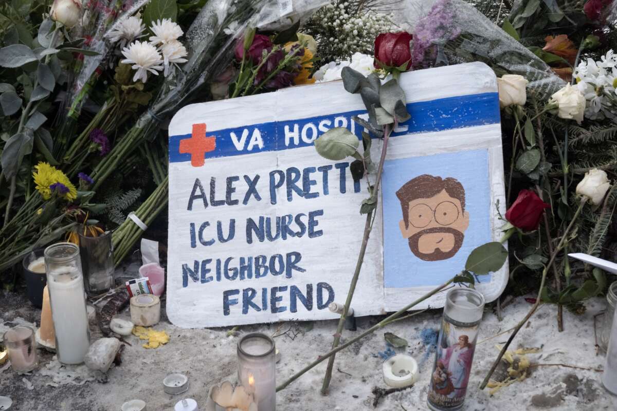 Flowers, candles and a homemade sign make up a memorial to Alex Pretti on January 25, 2026 in Minneapolis, Minnesota.