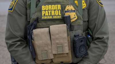 Closeup of Border Patrol agent's gear at protest at the Whipple Federal building in response to the killing of a woman by an Immigration and Customs Enforcement officer.