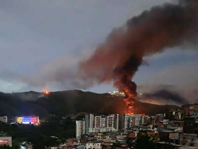 Fire at Fuerte Tiuna, Venezuela's largest military complex, is seen from a distance after a series of U.S. military strikes against Caracas on January 3, 2026.