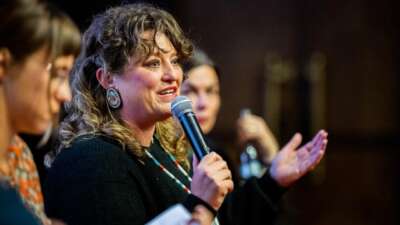 Angel Ellis speaking at the Millennium Docs Against Gravity Film Festival in Poland, 2023, where the documentary Bad Press was screened.