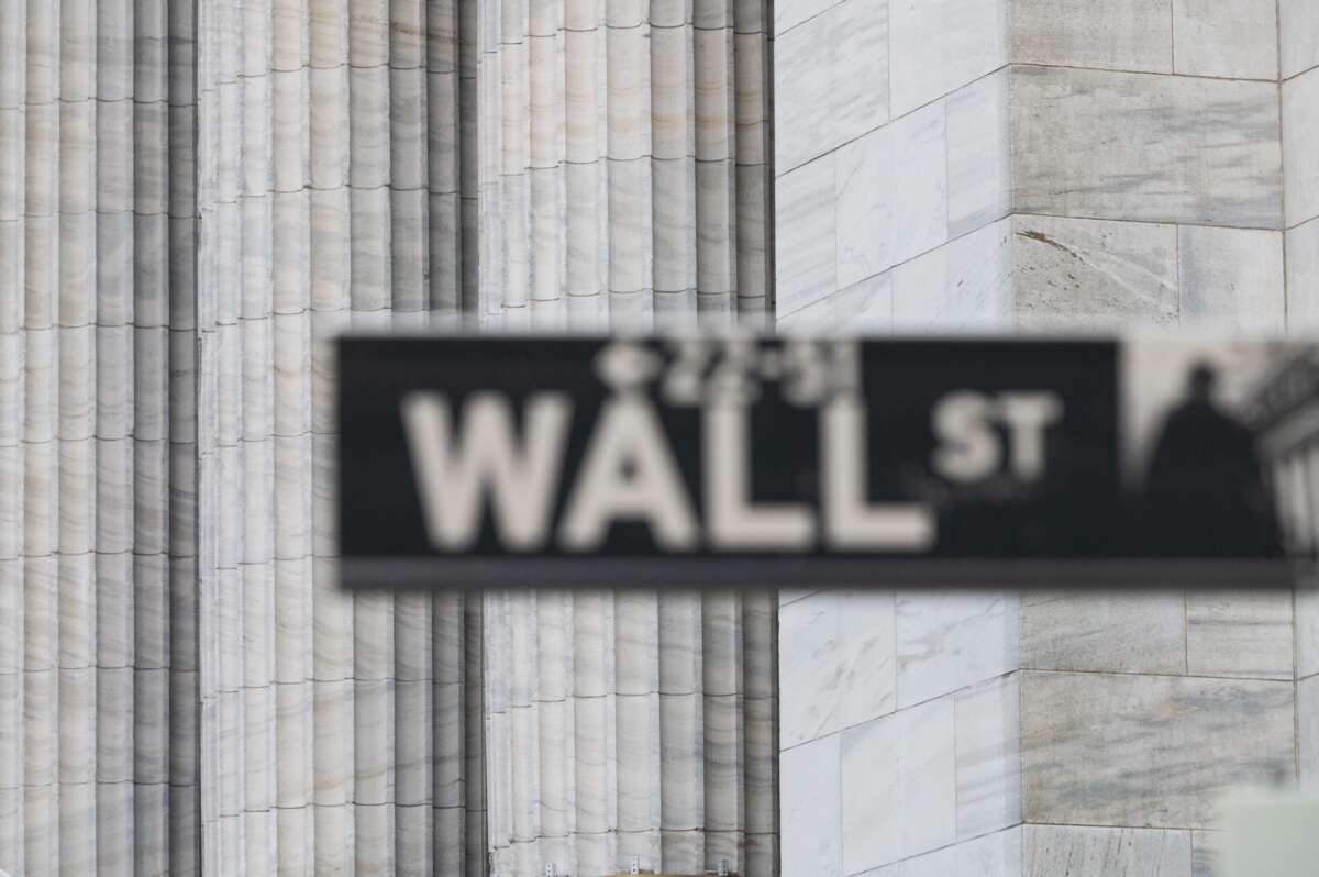 A Wall Street sign hangs at the New York Stock Exchange on Wall Street on March 23, 2021, in New York City.