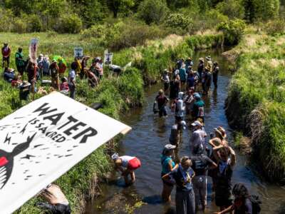 Indigenous community members and climate activists gather on the river for a traditional water ceremony during a rally and march to protest the construction of the Enbridge Line 3 pipeline in Solvay, Minnesota, on June 7, 2021.