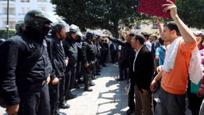 Tunisian riot police block the central Habib Bourguiba Avenue in Tunis on May 6, 2011, during a demonstration organized by youths denouncing the transitional government and calling for "a new revolution." Riot police used tear gas and truncheons to break up a protest in central Tunis on May 6, attacking reporters and photographers covering the event.