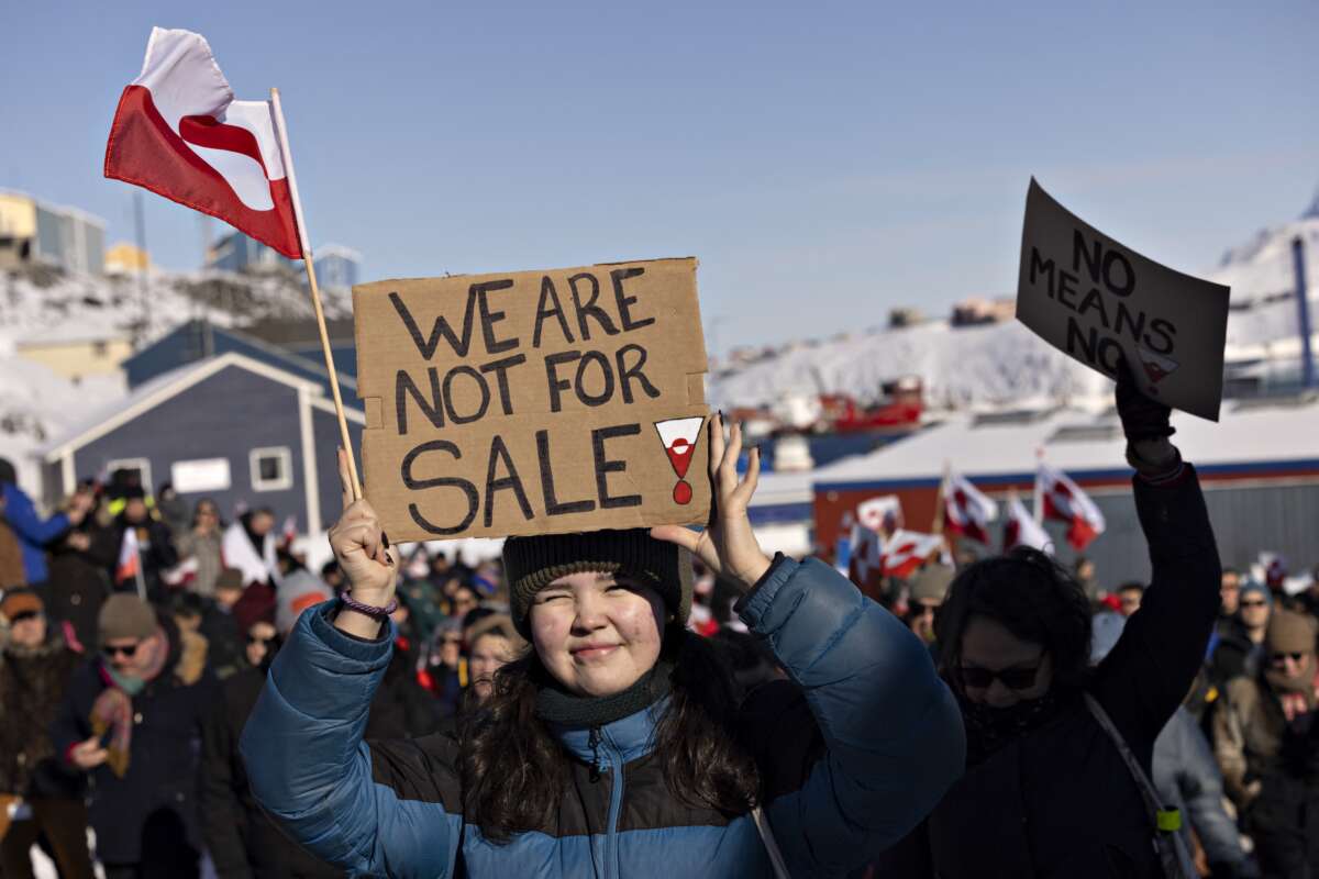 A protester holds a sign reading “We are not for sale” in front of the U.S. consulate during a demonstration in Nuuk, Greenland, on March 15, 2025.