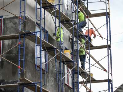 Construction workers build a structure in Katy, Texas, on April 2, 2025.