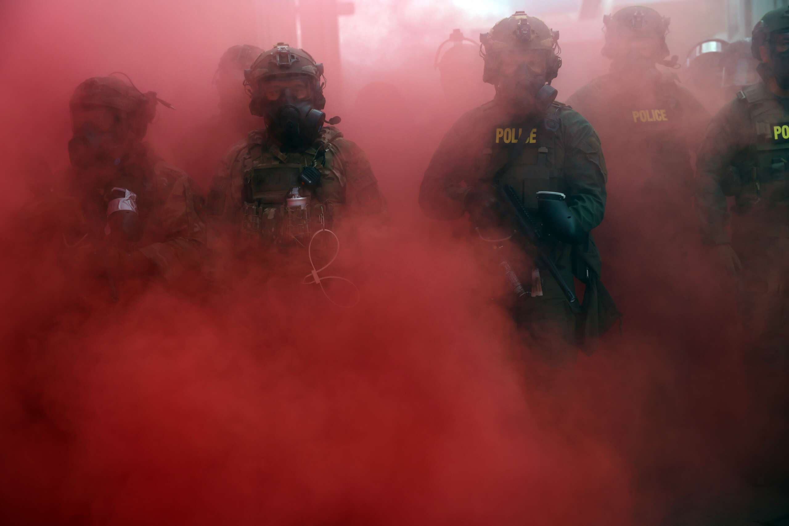 Federal agents, including members of the Department of Homeland Security and the Border Patrol, deploy a smoke grenade outside a downtown Immigration and Customs Enforcement facility in Portland, Oregon, on October 4, 2025.