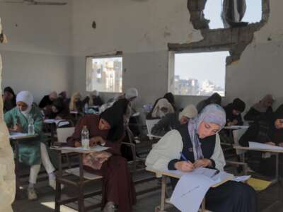 Students take their exams in a damaged classroom at the Al-Azhar institutes in Gaza City on November 18, 2025.