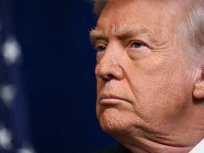 Donald Trump looks on as Israeli Prime Minister Benjamin Netanyahu (off frame) speaks to journalists during a joint press conference at Trump's Mar-a-Lago residence in Palm Beach, Florida, on December 29, 2025.