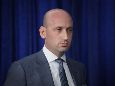 White House Deputy Chief of Staff and Homeland Security Advisor Stephen Miller listens as President Donald Trump addresses the media during a news conference at his Mar-a-Lago club on January 3, 2026, in Palm Beach, Florida.