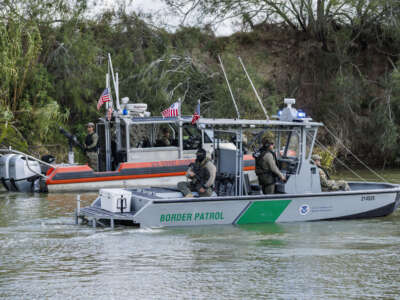 A U.S. Coast Guard and U.S. Border Patrol boat patrol the Rio Grande river on January 7, 2026, in Brownsville, Texas.