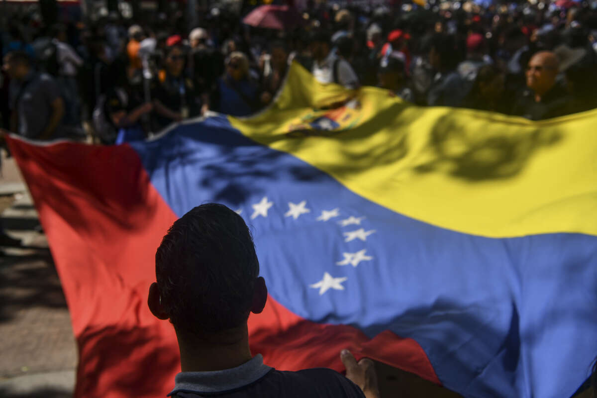 People wave a Venezuelan flag during a demonstration in Caracas, Venezuela, on January 8, 2026.