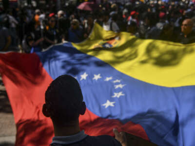 People wave a Venezuelan flag during a demonstration in Caracas, Venezuela, on January 8, 2026.