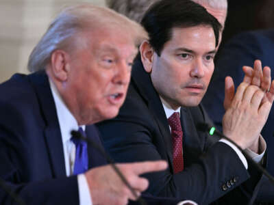 U.S. Secretary of State Marco Rubio (R) listens as US President Donald Trump (L) speaks during a meeting with oil company executives in the East Room of the White House in Washington, D.C., on January 9, 2026.