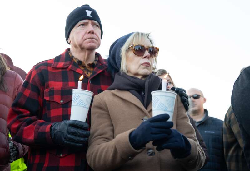 Gov. Tim Walz and First Lady Gwen Walz hold candles on the Capitol steps in St. Paul, Minnesota, as participants in an interfaith vigil remember the life of Renee Nicole Good.