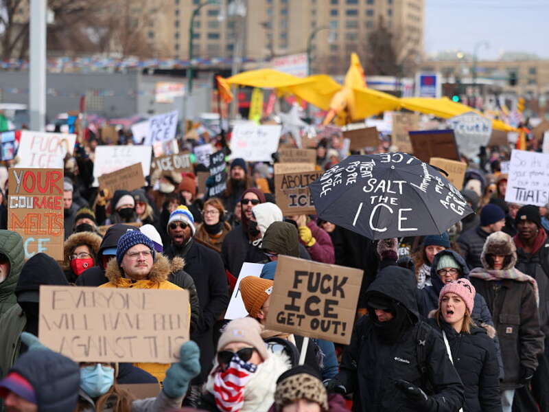 People holding up signs protest on the streets