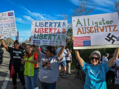 Demonstrators protest against Immigration and Customs Enforcement (ICE) and demand the closure of the immigrant detention center known as "Alligator Alcatraz" outside the center at the Dade-Collier Training and Transition Airport in Ochopee, Florida, on January 11, 2026.