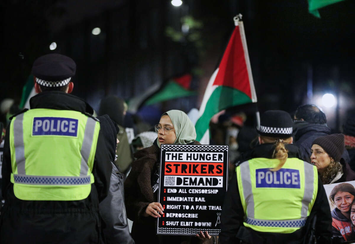 Shamina Alam, the sister of hunger striker Kamran Ahmed, holds a sign outlining the hunger striker's demands in London, UK, on January 11, 2026.