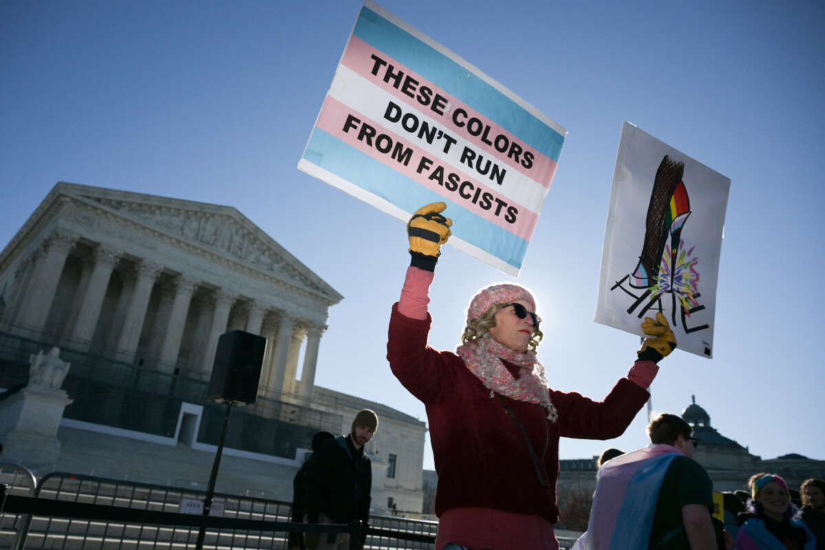 LGBTQ+ rights advocates rally outside the U.S. Supreme Court as justices hear arguments in challenges to state bans on transgender athletes in women's sports on January 13, 2026, in Washington, D.C.