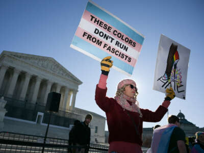 LGBTQ+ rights advocates rally outside the U.S. Supreme Court as justices hear arguments in challenges to state bans on transgender athletes in women's sports on January 13, 2026, in Washington, D.C.