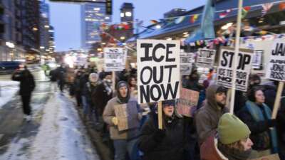Demonstrators march during the nationwide "Stop ICE Terror" rally through downtown Minneapolis, Minnesota, on January 20, 2026, in protest against Donald Trump's policies.