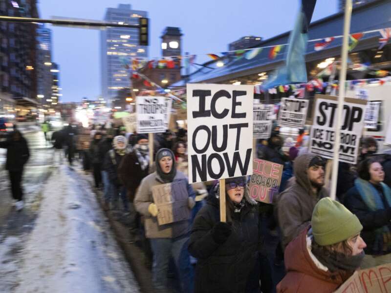 Demonstrators march during the nationwide "Stop ICE Terror" rally through downtown Minneapolis, Minnesota, on January 20, 2026, in protest against Donald Trump's policies.
