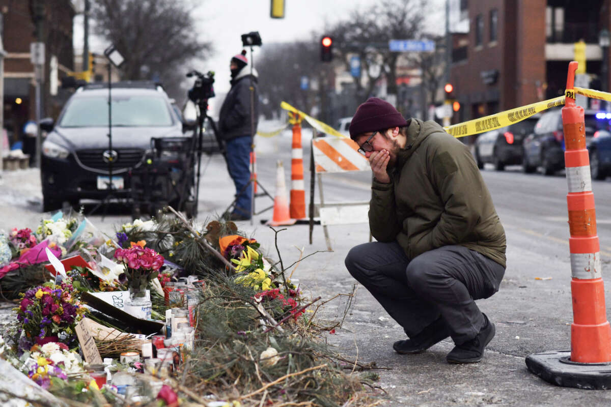 A mourner visits a makeshift memorial in the area where Alex Pretti was shot dead a day earlier by federal immigration agents in Minneapolis, Minnesota, on January 25, 2026.