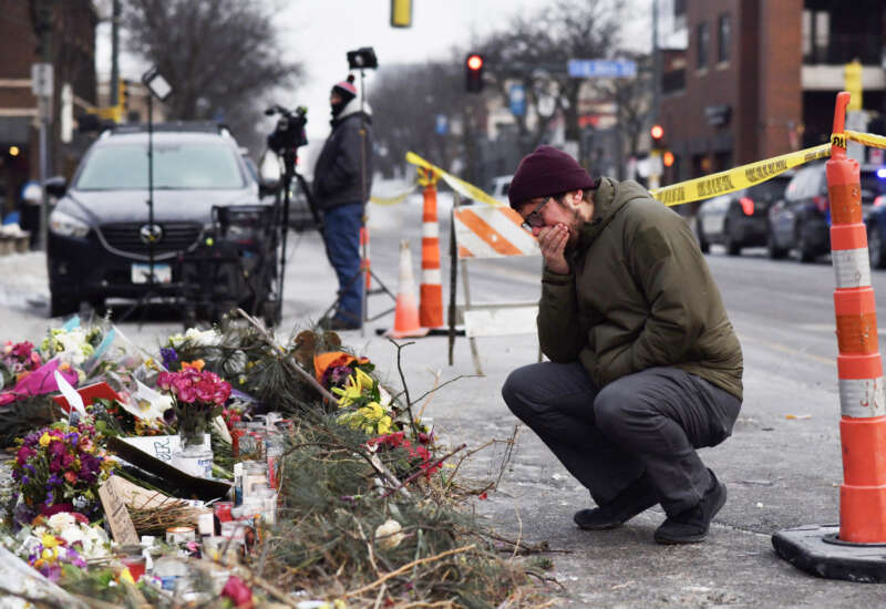 A mourner visits a makeshift memorial in the area where Alex Pretti was shot dead a day earlier by federal immigration agents in Minneapolis, Minnesota, on January 25, 2026.