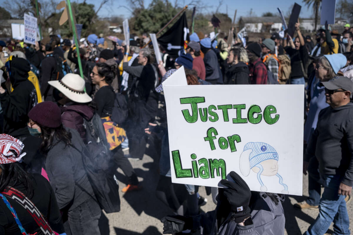 People protest against Immigration and Customs Enforcement as they march toward the South Texas Family Residential Center on January 28, 2026, in Dilley, Texas. A federal judge temporarily blocked the deportation of 5-year-old Liam Conejo Ramos and his father, Adrian Conejo Arias, who were arrested in Minneapolis after the father had picked the boy up from school.