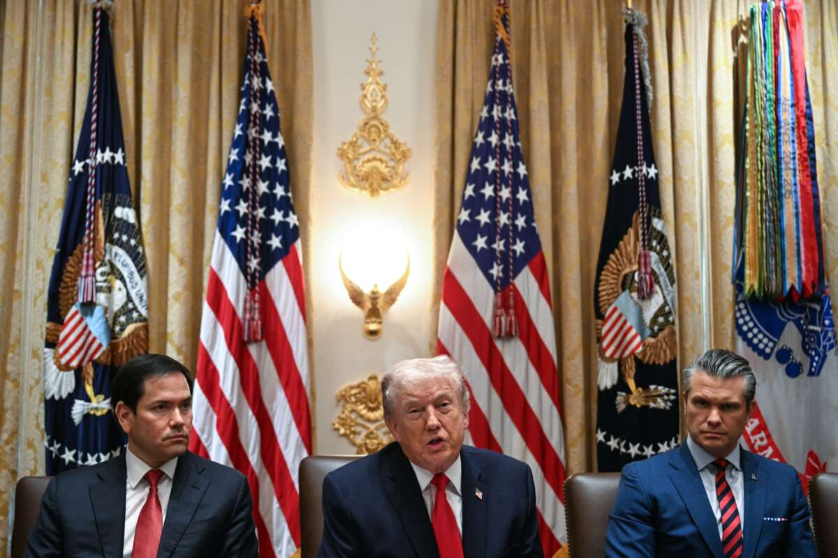 President Donald Trump speaks alongside Secretary of State Marco Rubio (L) and Defense Secretary Pete Hegseth (R) during a cabinet meeting in the Cabinet Room of the White House in Washington, D.C., on January 29, 2026.