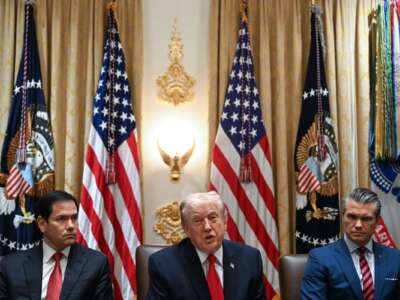 President Donald Trump speaks alongside Secretary of State Marco Rubio (L) and Defense Secretary Pete Hegseth (R) during a cabinet meeting in the Cabinet Room of the White House in Washington, D.C., on January 29, 2026.