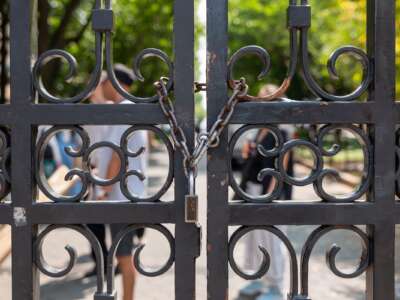 Gates are locked as students, faculty, and others wait to enter Columbia University's campus on August 15, 2024, in New York City, after the school instituted new security rules before the start of the academic year.