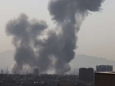 A plume of smoke rises following a reported explosion in Tehran, Iran, on February 28, 2026.