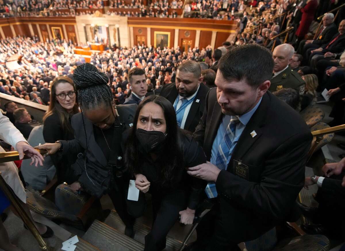 Authorities take Aliya Rahman, a guest of Rep. Ilhan Omar (D-Minnesota) and a Minneapolis resident who was detained by DHS agents, out of the chamber as Trump delivers his State of the Union address during a Joint Session of Congress at the U.S. Capitol on February 24, 2026, in Washington, D.C.